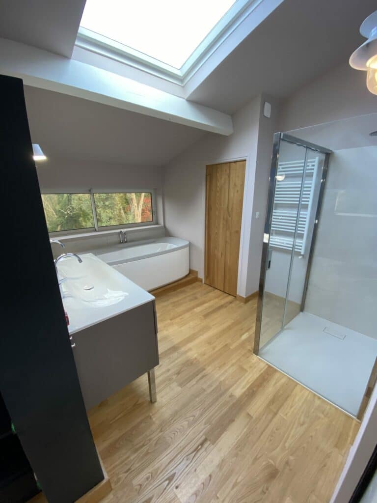 Une salle de bain bois sous toit en pente